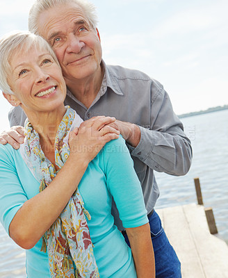 Buy stock photo A senior couple embracing and looking upwards