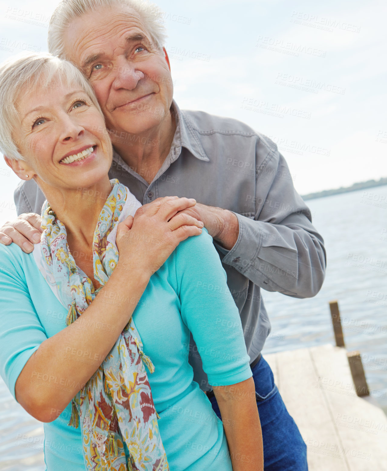 Buy stock photo Senior couple, hug and blue sky on lake with support, retirement vacation and travel destination. Below, people and mockup space with affection, partner love and marriage commitment for pier holiday