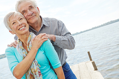 Buy stock photo Thinking, happy and love with old couple at lake for retirement, vacation and bonding. Support, anniversary getaway and reflection with senior man and woman in nature for connection, view or marriage