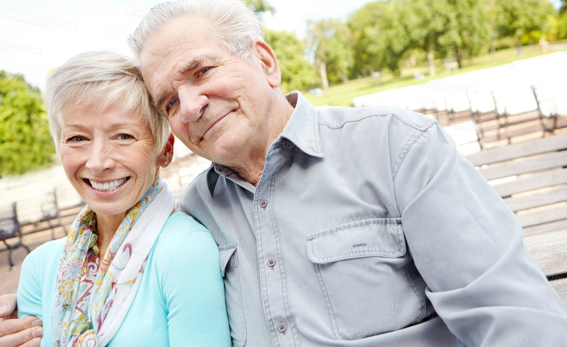 Buy stock photo Shot of an elderly man putting his arm around his wife