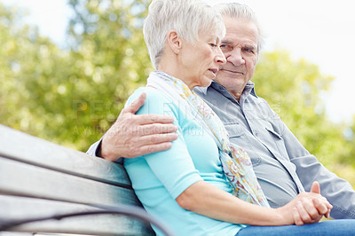 Buy stock photo Image of a mature man consoling his wife on a park bench