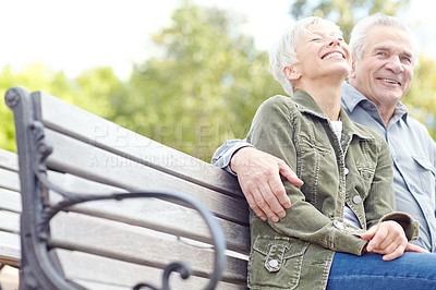 Buy stock photo Senior couple, laugh and smile in park for bonding, conversation and commitment together outdoors. Retirement, marriage and mature man and women in nature on bench for love, care and connection