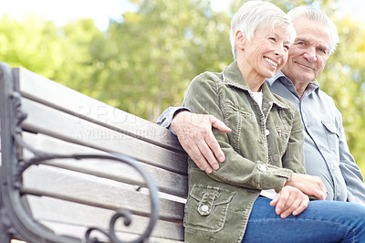 Buy stock photo A mature couple sitting on a bench in the park