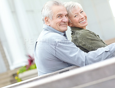 Buy stock photo Portrait of a senior couple sitting together on a bench