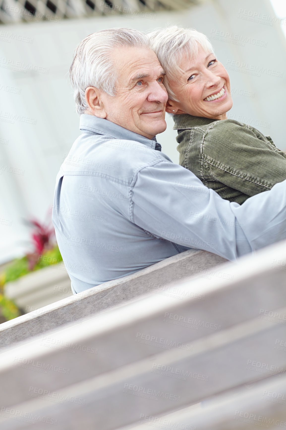 Buy stock photo Image of a mature man and woman sitting on a bench 