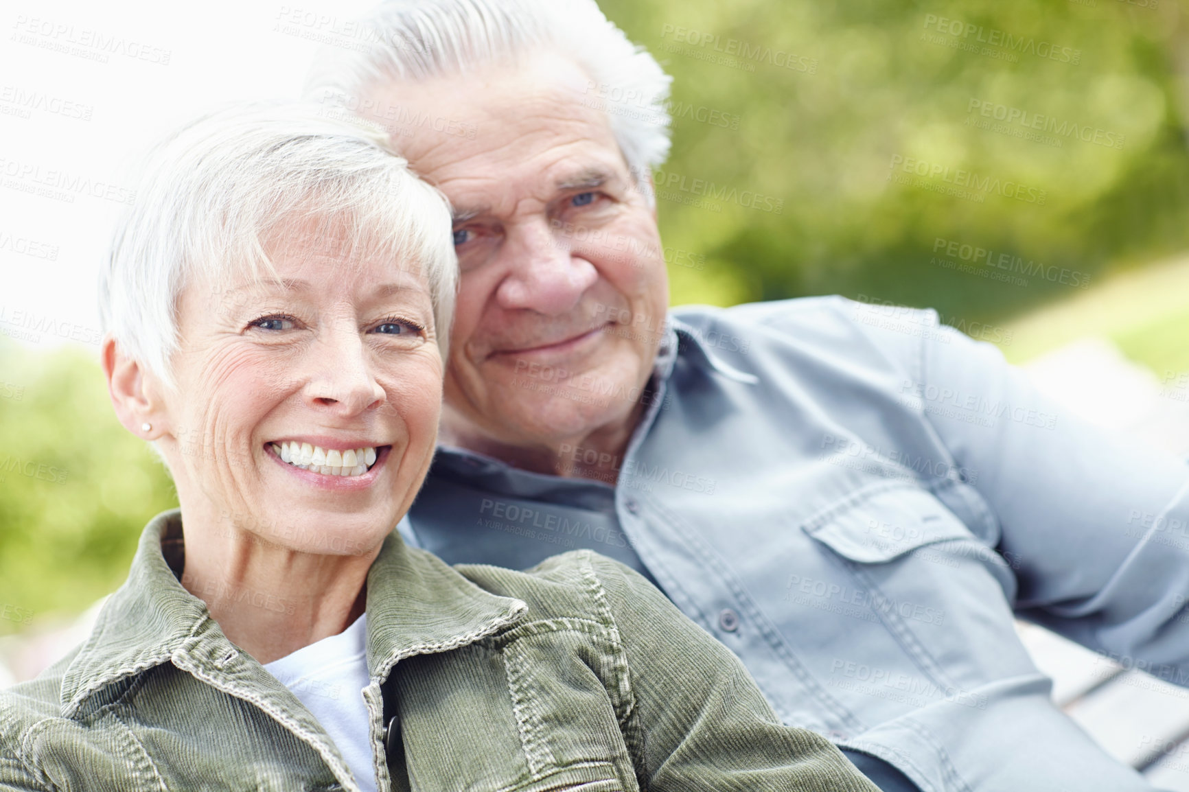 Buy stock photo Cropped image of a mature husband and wife sitting together on a bench