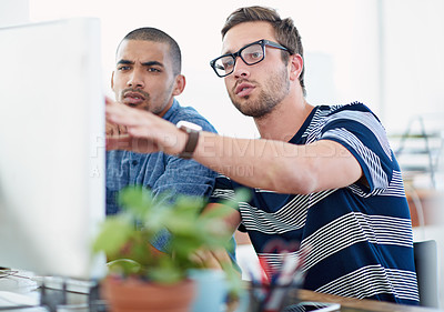 Buy stock photo Shot of two male designers working together at a computer