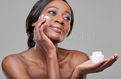 Buy stock photo Black woman, skin cream and jar in studio for beauty with application, cosmetics and idea by gray background. Girl, model and person with thinking, skincare and moisturizer serum for facial glow