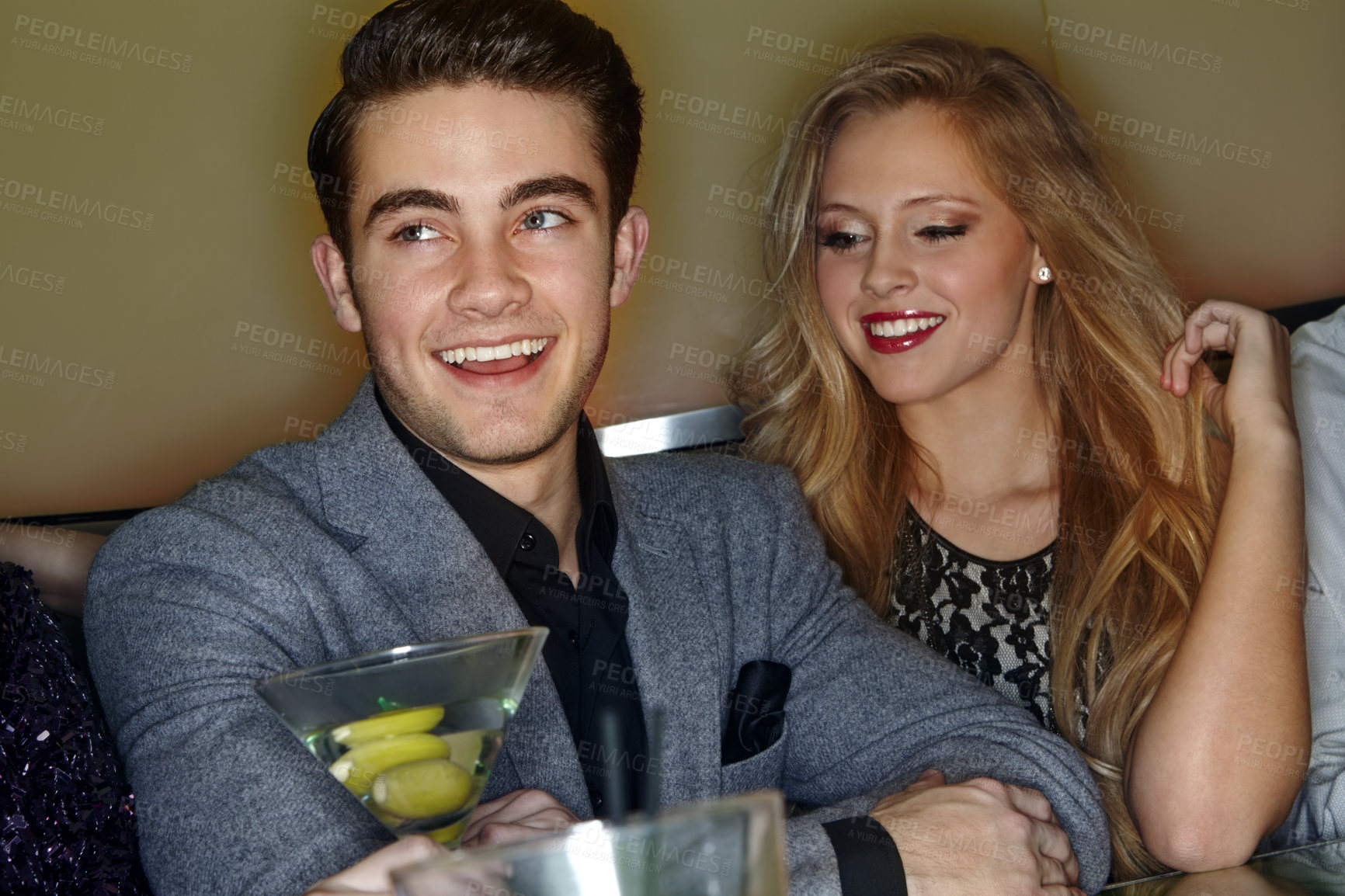 Buy stock photo A young couple enjoying cocktails in a night club