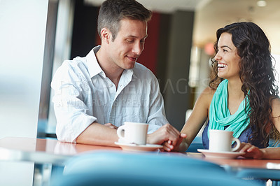 Buy stock photo A young couple enjoying a casual date over coffee