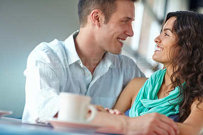 Buy stock photo A handsome young man looking into his beautiful girlfriend's eyes