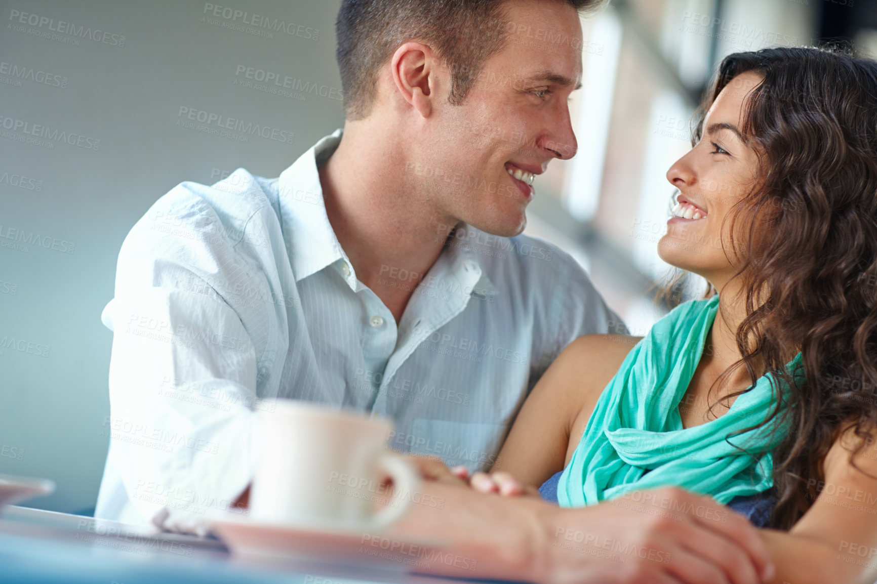 Buy stock photo Couple, embrace and love at cafe with talk, bonding or eye contact with happy memory in morning. Man, woman and support with conversation, drinks or tea with smile, loyalty and trust at restaurant