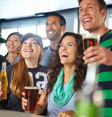 Buy stock photo A group of friends cheering on their favourite sports team at the bar