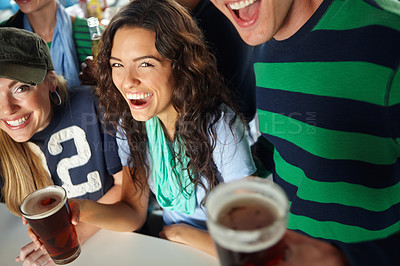 Buy stock photo A stunning young woman enjoying a beer at the bar with friends