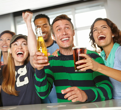 Buy stock photo A group of friends cheering on their favourite team at the bar