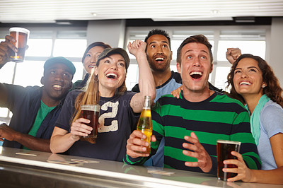 Buy stock photo A group of friends cheering on their favourite team at the bar
