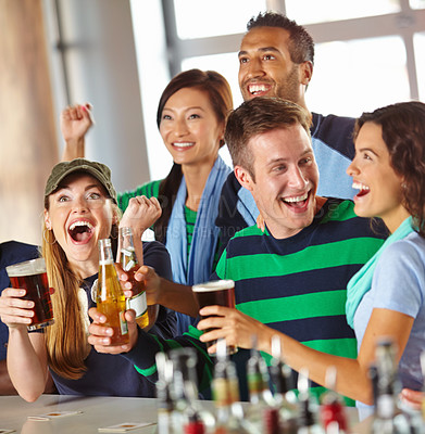 Buy stock photo A gorgeous woman cheering her team excitedly while out drinking with friends