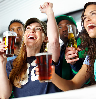 Buy stock photo A pretty woman watching sport at the bar with her friends