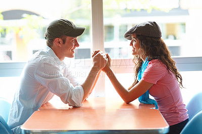 Buy stock photo Couple, holding hands and happy at coffee shop for love, bonding or care with funny joke in morning. Man, woman and support with conversation, connection and smile for memory with trust at restaurant