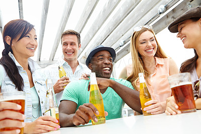 Buy stock photo A group of friends enjoying drinks on the deck of a trendy outdoors restaurant