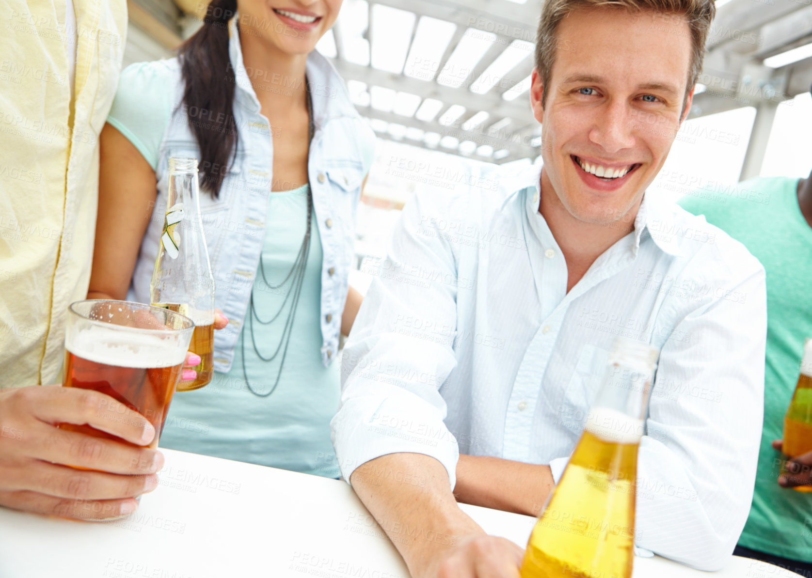 Buy stock photo Portrait of a handsome young man enjoying drinks on the outdoors deck of a restaurant