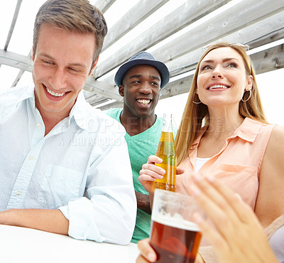 Buy stock photo A pretty woman drinking with friends on an outdoor deck