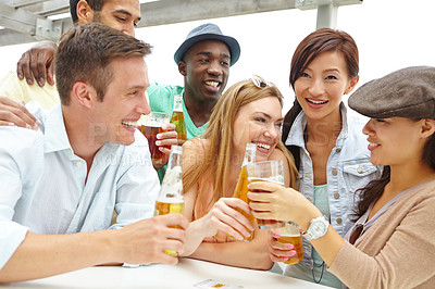 Buy stock photo Cheers, friends and group with alcohol, bar and celebration for reunion with liquor, happy and fun. Laughing, toast and people with funny stories in pub, humor and drinks for good news in weekend