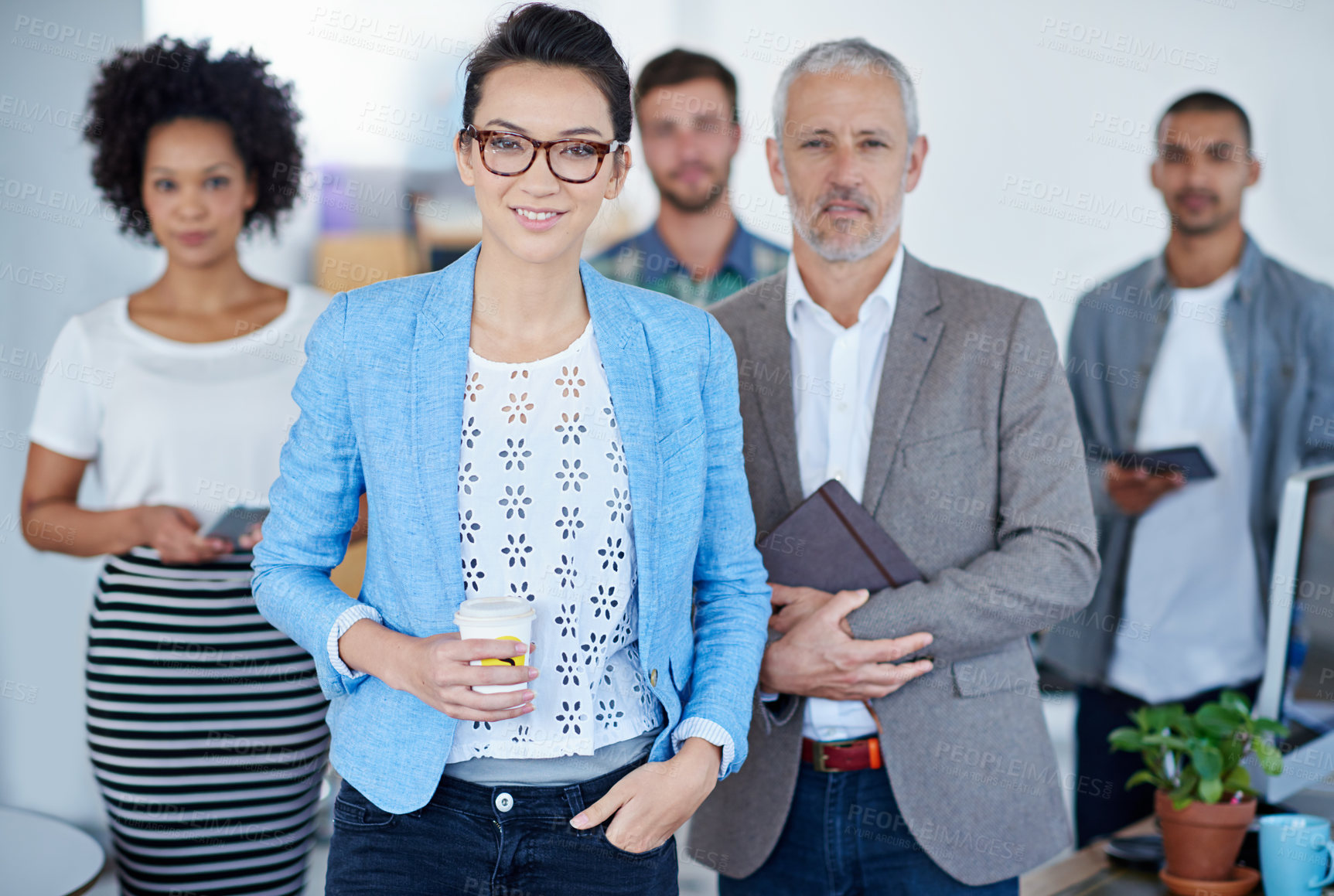 Buy stock photo Portrait of a group of happy coworkers standing in an office