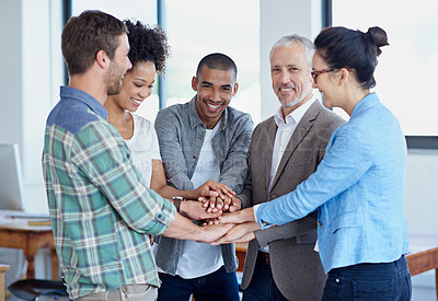 Buy stock photo Shot of a group of happy coworkers standing in an office