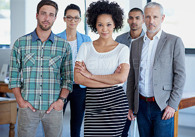 Buy stock photo Shot of a group of focused coworkers standing in an office