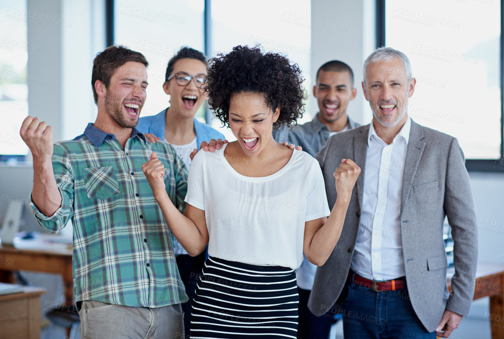 Buy stock photo Shot of a group of happy coworkers standing in an office