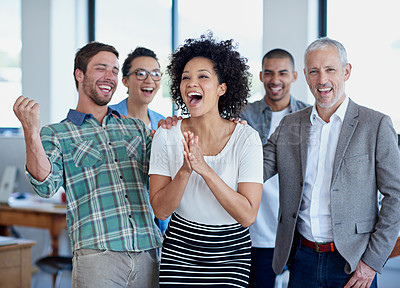 Buy stock photo Shot of a group of happy coworkers celebrating standing in an office