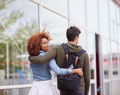 Buy stock photo Students, couple and walking on campus for university, love and study with portrait or hug. Man, woman and strolling outdoor at school for college, relationship and education with face or backpack