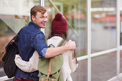Buy stock photo Students, couple and walking on campus for college, love and study with portrait or hug. Man, woman and strolling outdoor at school for university, relationship and education with face or backpack
