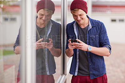 Buy stock photo Cellphone, smile and man in window reflection, texting and social media for student on campus. Technology, smartphone for communication for male learner, laugh and meme online for entertainment  