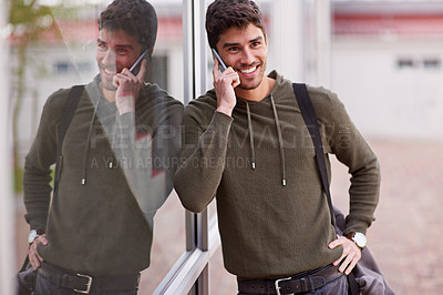 Buy stock photo Phone call, smile and man by window, chat and network for student on campus. Technology, smartphone and discussion for male learner, talking and social for communication or conversation at university
