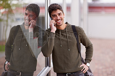 Buy stock photo Phone call, smile and man by window, chat and network for student on campus. Technology, smartphone and discussion for happy male learner, talking and social for communication or fun at university
