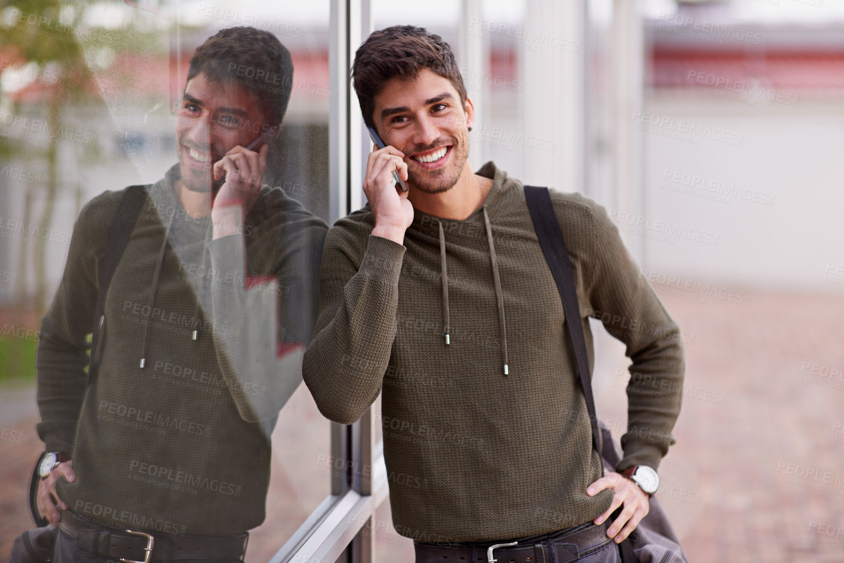 Buy stock photo Phone call, smile and man by window, chat and network for student on campus. Technology, smartphone and discussion for happy male learner, talking and social for communication or fun at university