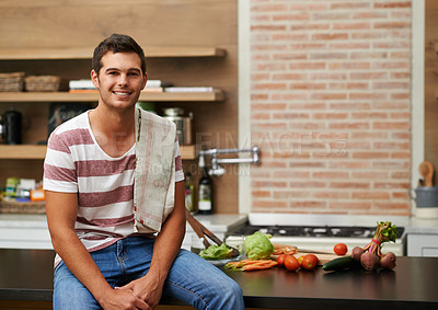 Buy stock photo Cooking, happy and portrait of man in kitchen for food, wellness and nutrition with confidence. Healthy dinner, diet and chef cutting vegetables with towel at home for lunch, vegan or salad in France