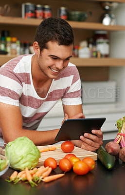 Buy stock photo Online, man and cooking with recipe on tablet in kitchen to watch tutorial video with instructions. Learning, guide and person reading healthy food info on mobile app in home to diet with nutrition