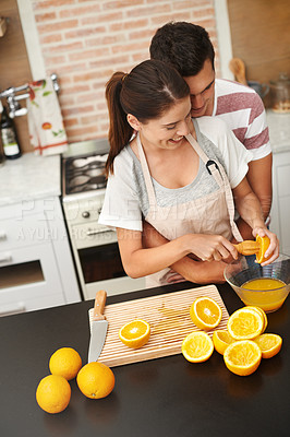 Buy stock photo Couple, hug and fruit in orange juice with happy, health and wellness in winter or season. Man, woman and cheerful in preparing citrus for nutrition, vitamin c and diet for fresh, squeezed and drink
