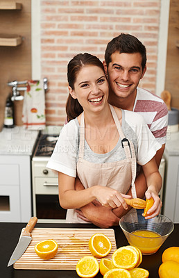 Buy stock photo Portrait, couple and hug with orange juice in happy, healthy and wellness for breakfast. Man, woman and cheerful in preparing fruit for nutrition, vitamin c and diet for fresh, squeezed and drink
