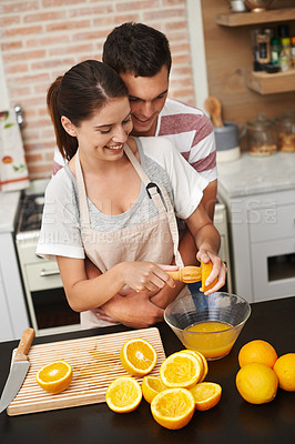 Buy stock photo Couple, hug and fruit in orange juice with smile, health and wellness in winter or season. Man, woman and cheerful in preparing citrus for nutrition, vitamin c and diet for fresh, squeezed and drink