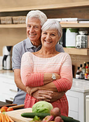 Buy stock photo Cooking, love and portrait of old couple in kitchen for salad, health or nutrition. Happy, smile and retirement with senior man hugging woman and cutting vegetables at home for food, dinner or recipe
