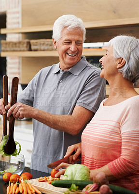Buy stock photo Cooking, health and laughing with old couple in kitchen for salad, love and nutrition. Happy, smile and retirement with senior man and woman cutting vegetables at home for food, dinner and recipe