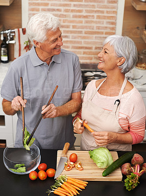 Buy stock photo Cooking, health and smile with old couple in kitchen for salad, love and nutrition. Happy, help and retirement with senior man and woman cutting vegetables at home for food, dinner and recipe