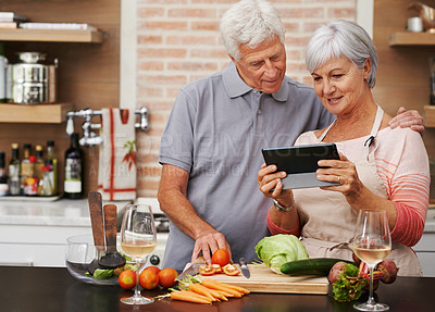 Buy stock photo Senior couple, tablet and vegetables for cooking wholesome, healthy and nutritional food at home. Husband, wife and digital device for researching ingredients, recipes and delicious vegan meals