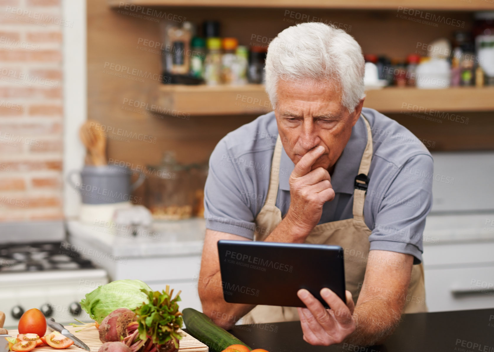 Buy stock photo Senior man, tablet and vegetables for cooking wholesome, healthy and nutritional food at home. Retired male, ingredients and digital device for researching diet, recipes and delicious vegan meals