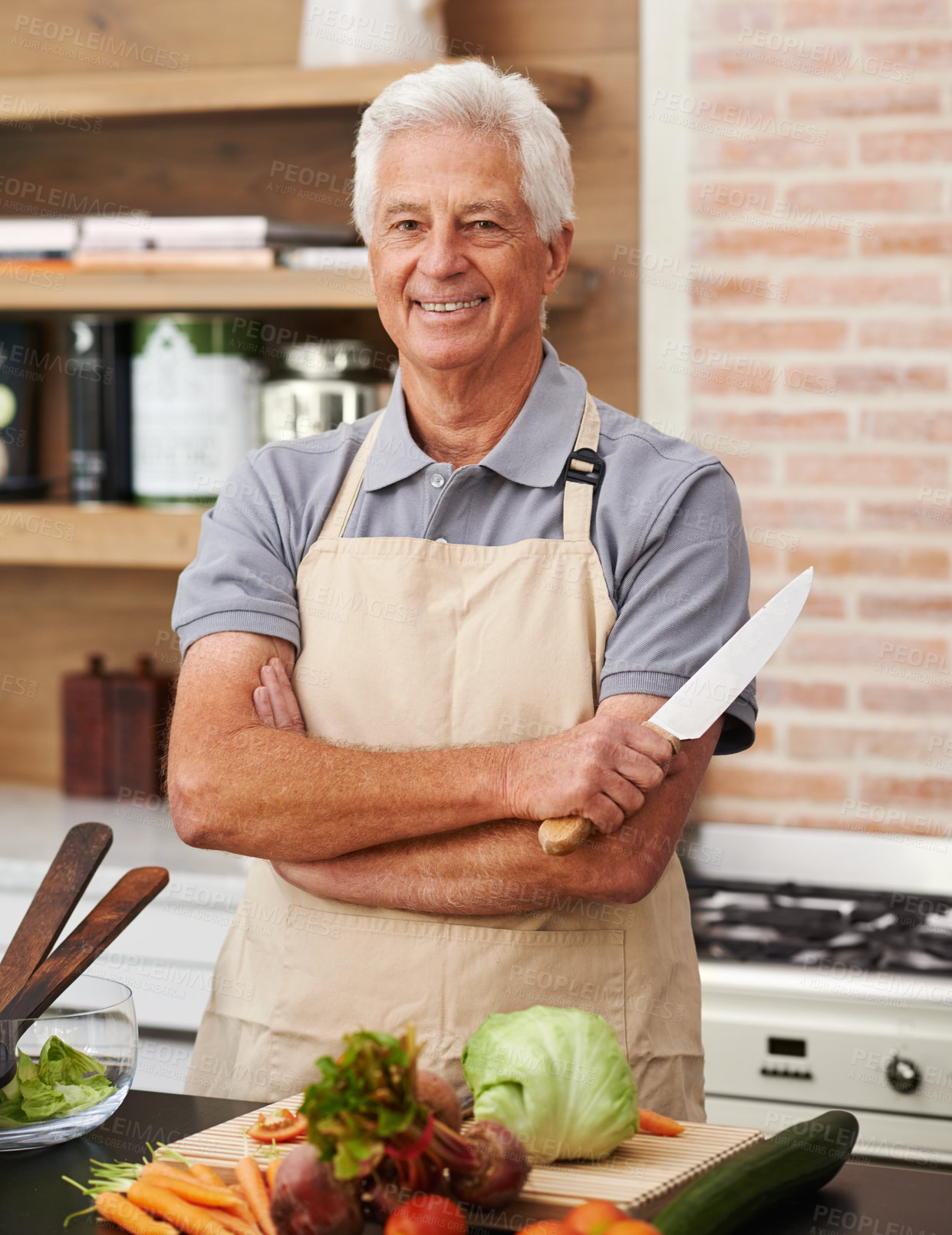 Buy stock photo Senior man and arms with knife in kitchen or confident, tomato and carrots for diet. Male chef and portrait with healthy vegetables for nutrition, peeling green lettuce with onion in retirement home