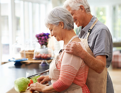 Buy stock photo Cooking, health and love with old couple in kitchen for salad,  help and nutrition. Happy, smile and retirement with senior man and woman cutting vegetables at home for food, dinner and recipe